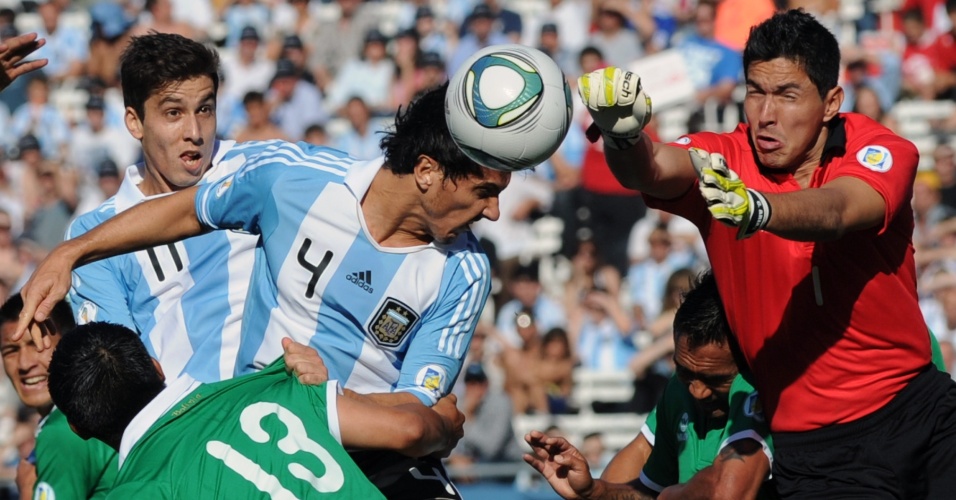 Burdisso tenta cabecear antes da chegada do goleiro Arias, no duelo entre Argentina e Bolívia