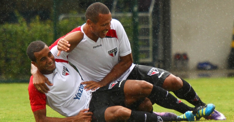 Luis Fabiano joga Lucas no chão e se diverte com o companheiro durante treino do São Paulo no CT de Cotia