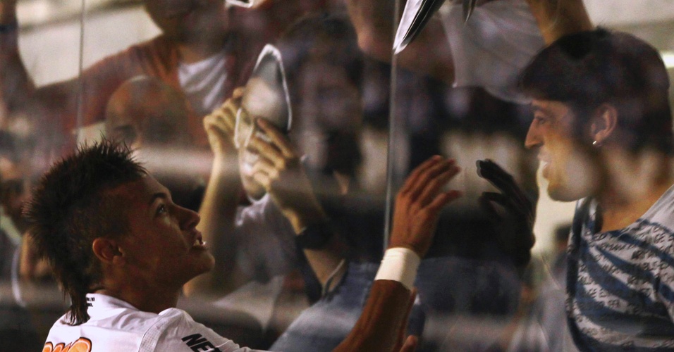 Neymar recebe máscara com seu rosto de Róbson, presente em um camarote na Vila (06/04/2011)