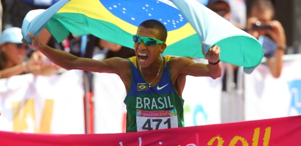 Solonei carrega a bandeira do Brasil ao cruzar a faixa para vencer a maratona do Pan